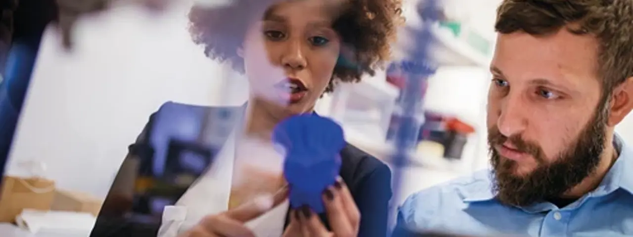 Woman and man looking at product in mid conversation